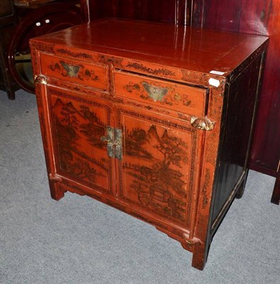 Lot 1253 - A Chinese Red Lacquer Side Cabinet, 20th century, decorated with mountainous landscapes with...