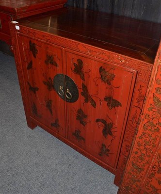 Lot 1254 - A Chinese Red Lacquer Two Door Cabinet, 20th century, decorated with butterflies, 77cm wide