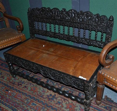 Lot 1280 - An 18th Century Sri Lanka Ebony Settee, with foliate carved back support, 118cm wide