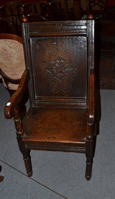 Lot 1283 - A Carved Oak Armchair, with fielded back support and rounded arms, 52cm wide