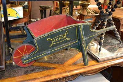 Lot 1302 - A Green and Red Painted Garden Wheel Barrow, initialled 'J.C.M.N', 87cm long