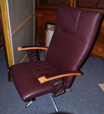 Lot 1309 - A Modern Leather Swivel Armchair, with beech arms and chrome base, 66cm wide