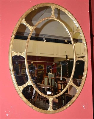 Lot 1352 - A Victorian Gilt and Gesso Oval Mirror, Mid 19th Century, the reeded and beaded oval frame with...