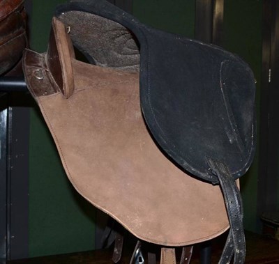 Lot 1424 - A Buckskin Western Saddle, with arched pommel and cantle, stirrup leathers and chrome stirrups; and