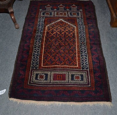 Lot 1459 - Baluch Prayer Rug West Afghanistan The burnt orange field of stylised flower heads beneath a...