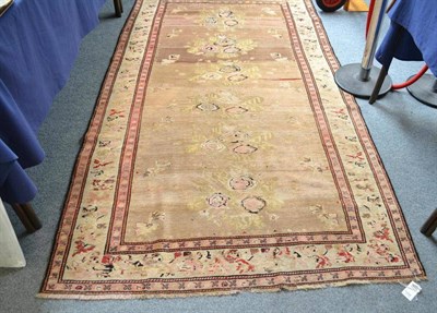 Lot 1466 - Karabagh Rug South Caucasus  The abrashed camel field with a column of naturalistic ";gul...