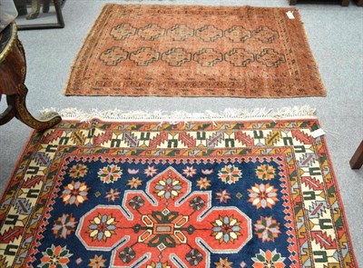 Lot 1472 - Caucasian Design Rug The indigo field with three medallions enclosed by leaf and calyx borders,...