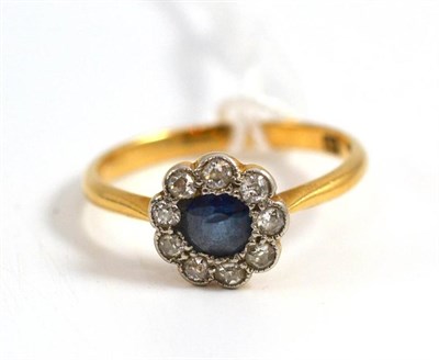 Lot 21 - A sapphire and diamond cluster ring stamped '18C', circa 1930, total estimated diamond weight...