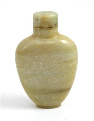 Lot 23 - A Chinese jade type spade shaped snuff bottle and cover, height 7.5cm