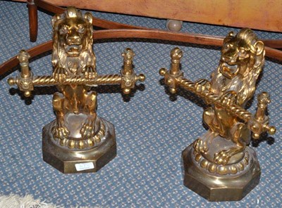 Lot 67 - A pair of gilt brass and steel andirons, 19th century, as lions seated on their haunches...