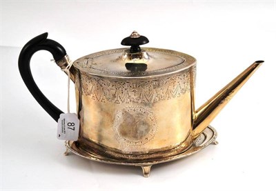Lot 87 - A George III silver teapot and stand, Benjamin Montague, London 1789, of oval form with wood scroll