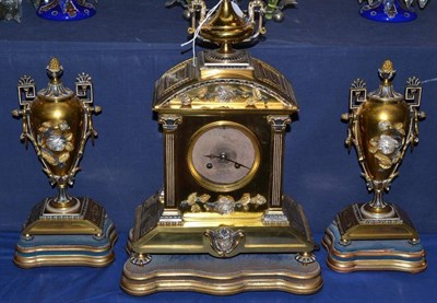 Lot 137 - A French gilt metal striking mantel clock garniture