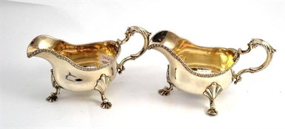 Lot 146 - A pair of silver sauce boats on shell feet, London 1906