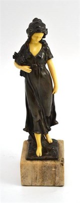 Lot 150 - An Art Nouveau patinated bronze and ivorine figure, modelled as a peasant girl, on an onyx...