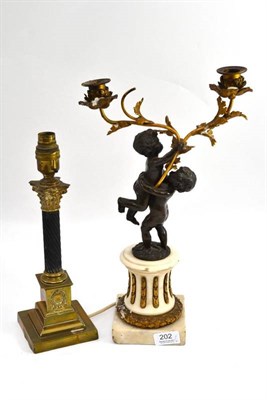 Lot 202 - Late 19th century bronze and gilt metal candelabra, height 41cm and a brass table lamp