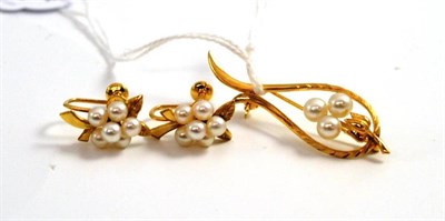 Lot 254 - A cultured pearl set brooch and a pair of earrings by Mikimoto