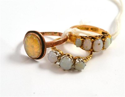 Lot 255 - Two 9ct gold opal rings and another stamped '18' (3)