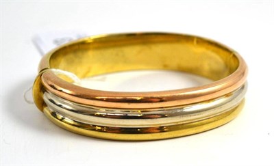 Lot 303 - A 9ct three colour gold bangle