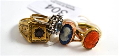 Lot 304 - A 9ct gold garnet ring, a 9ct gold sapphire ring, a Wedgwood ring, a 9ct gold cameo ring and a...