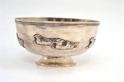 Lot 384 - A Chinese white metal circular footed bowl decorated with Mandarin ducks in relief, 13cm diameter