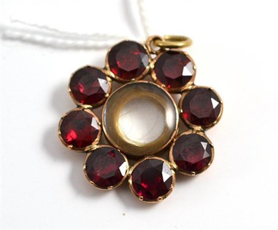 Lot 410 - A foil backed garnet locket pendant