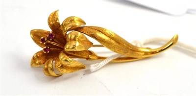 Lot 444 - An 18ct gold ruby set flower brooch