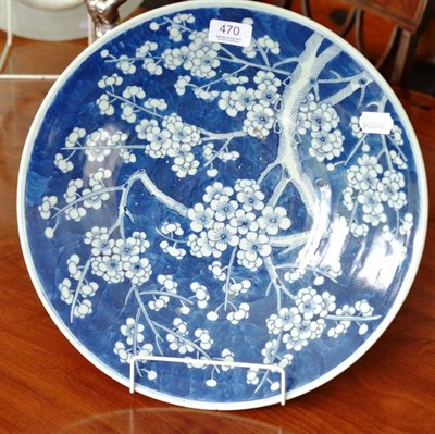 Lot 470 - A late 19th century Chinese charger decorated in under glaze blue with growing prunus blossom...