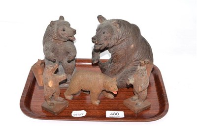 Lot 480 - Two Black Forest carved wooden seated bears, 18cm; together with three smaller (5)