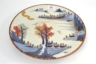 Lot 485 - A late 19th century Japanese Arita dish decorated with a stylised landscape, 35cm diameter