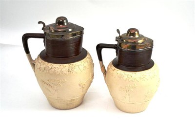 Lot 492 - Two 19th century salt glaze jugs with silver hinged lids, height 26cm and 23cm