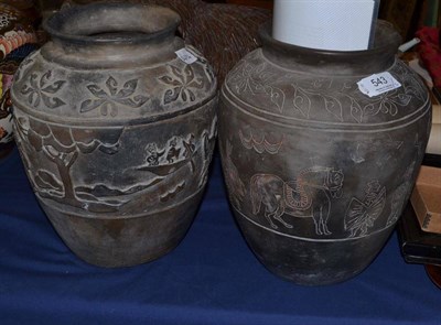 Lot 543 - A Thai Ban Chinang pottery urn, the shoulders with repeat orchid motifs over a continuous frieze of