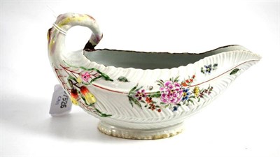 Lot 557 - A first period Worcester porcelain Cos lettuce leaf sauceboat, circa 1758, of traditional...