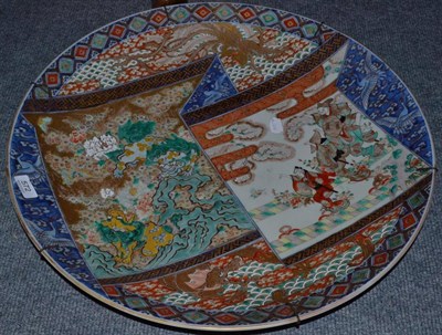 Lot 572 - A late 19th century Japanese Imari charger decorated with panels of shishi and figures within...