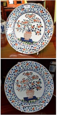 Lot 594 - A pair of Imari porcelain dishes, 18th century, painted with jardinières of foliage in...