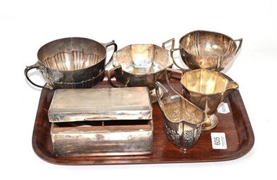 Lot 605 - Three double handled silver bowls, two silver cream jugs and silver cigarette box with engine...