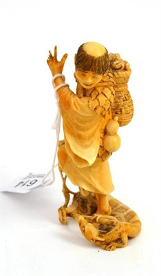 Lot 614 - A Japanese carved ivory figure of Liuhai (or a kappa), circa 1880, carrying toads in a basket...