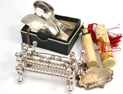 Lot 633 - Silver baby's spoon, four knife rests, decanter label, two scent bottle holders etc