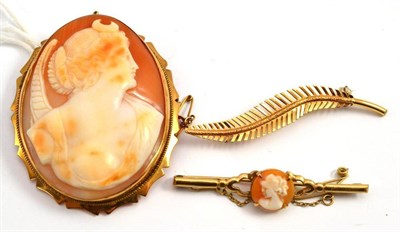 Lot 639 - Two cameo brooches and a leaf brooch