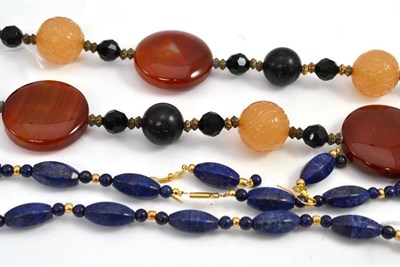 Lot 645 - A multi stone necklace, including cornelian, onyx and carved yellow beads and a lapis lazuli...