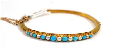 Lot 666 - A turquoise and half pearl set bangle