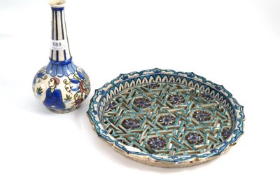 Lot 688 - A Kajar faience bottle vase, 24cm high; and Middle Eastern faience pierced dish, diameter 34cm (2)