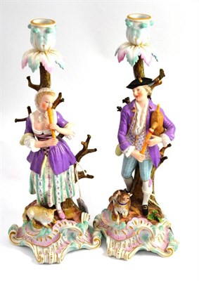 Lot 695 - A pair of Meissen porcelain candlestick figures, late 19th century, as the musical shepherd and...