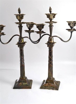 Lot 699 - A pair of silver plated two-branch three-light table candelabra, 19th century, in neo-classical...