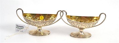 Lot 707 - A pair of George III two-handled pedestal boat shaped salts, Henry Chawner & John Emes, London...