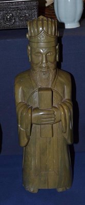 Lot 731 - A Chinese carved stone figure of a Confusion scholar, standing holding a tablet of rank, 37cm high