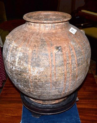 Lot 767 - A Japanese large wood-fired (?) and brown glaze ovoid jar with dribbled glaze, four lugs to the...