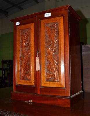 Lot 822 - An Edwardian walnut and carved oak miniature cabinet enclosing seven graduated drawers, width 40cm