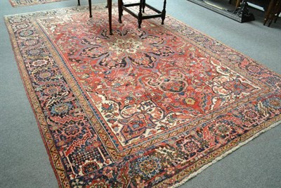 Lot 846 - Heriz Carpet, Persian Azerbaijan, the blood red field centred by a large flower head medallion...