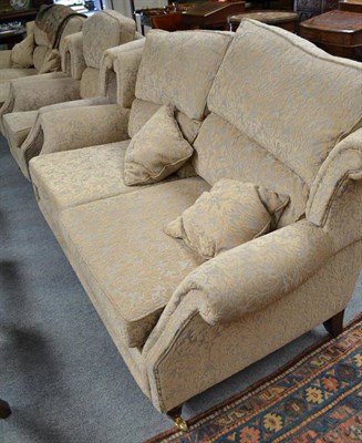 Lot 880 - A modern three piece suite comprising a pair of two seater sofas and a matching armchair raised...