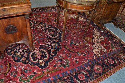 Lot 883 - Heriz carpet Persian Azerbaijan, the raspberry field centred by a cusped medallion with...